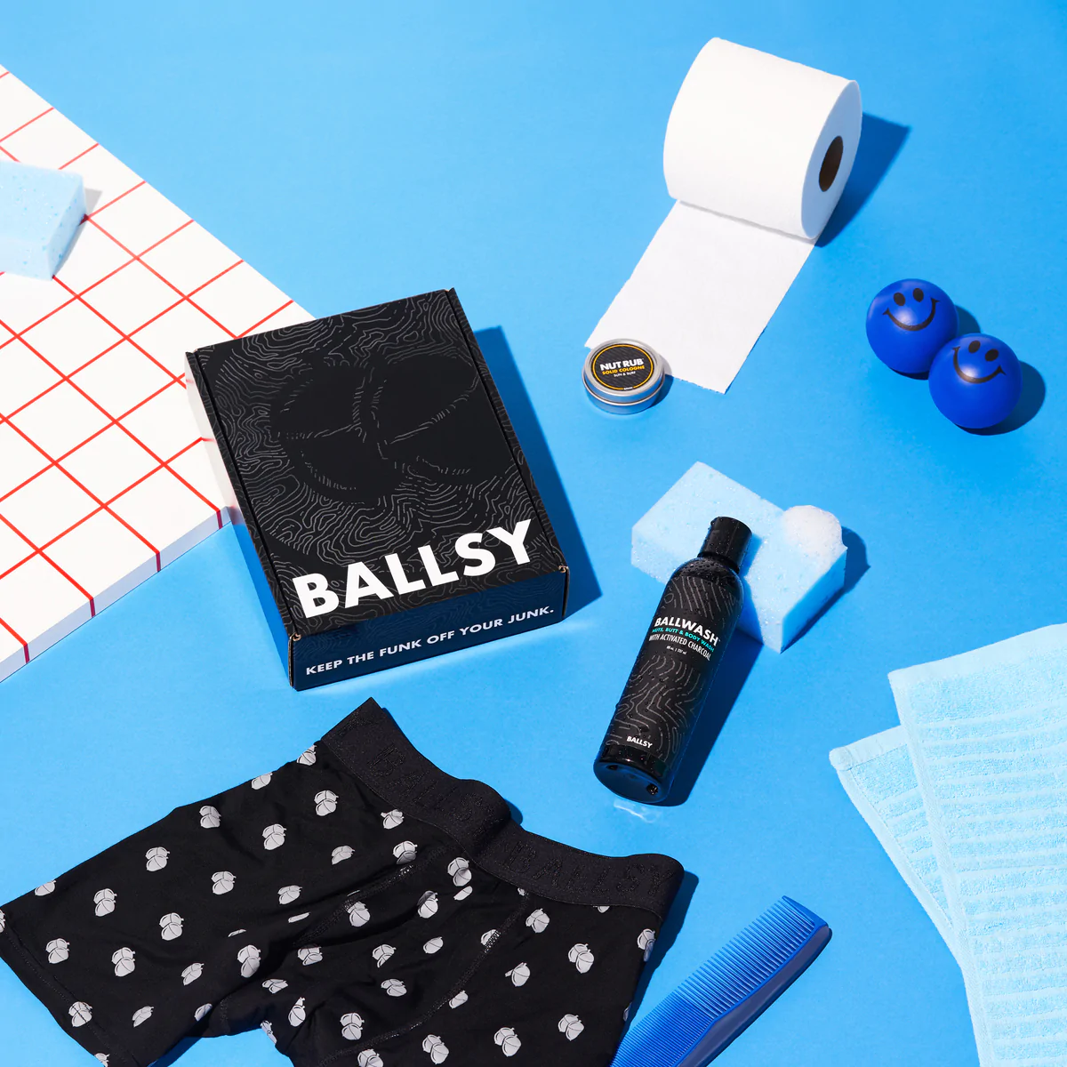 A package from Ballsy next to a pair of boxers and other bathroom items.