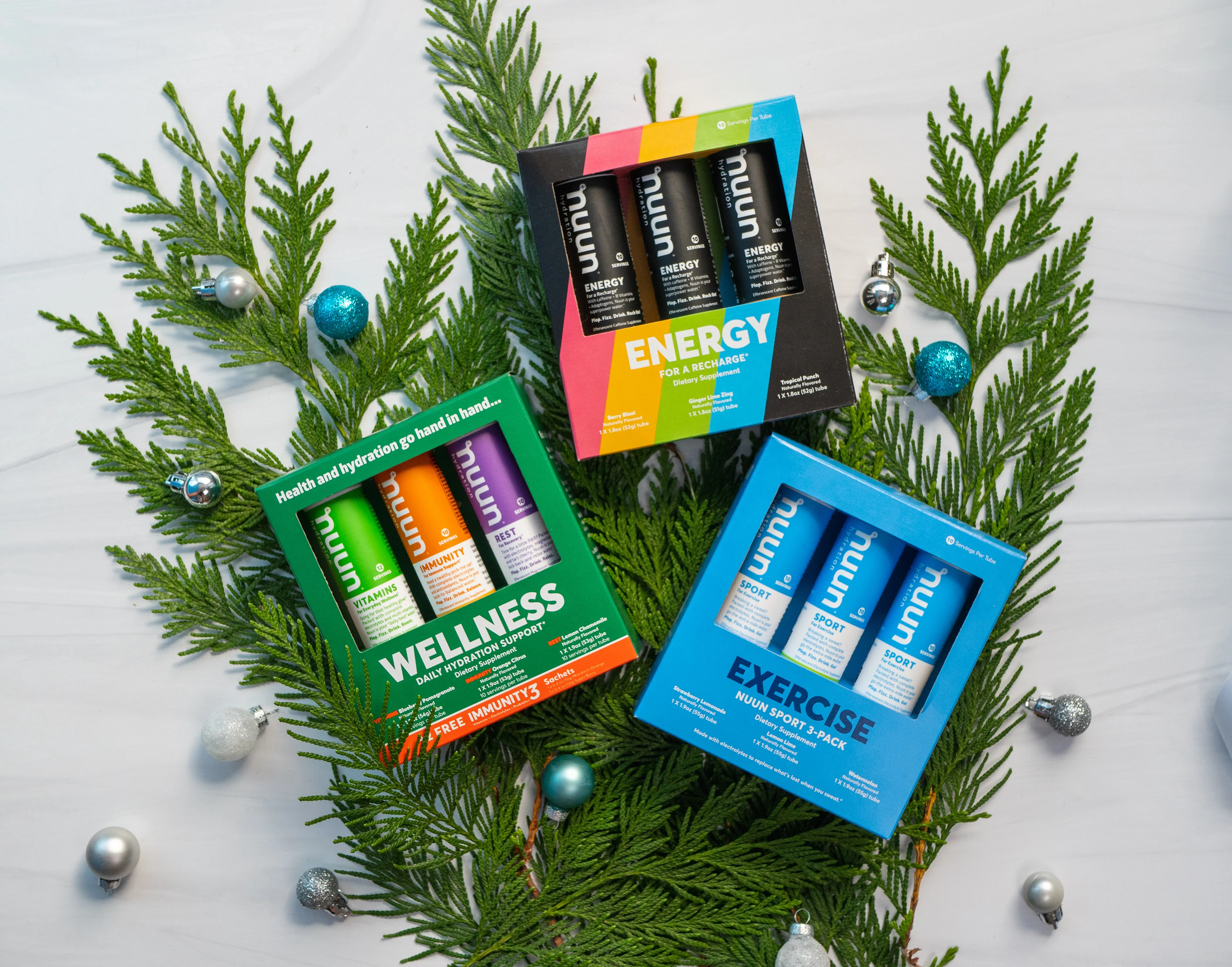 Gift sets of Nuun tablets arranged in a holiday scene